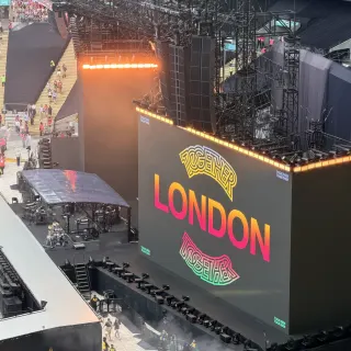 Looking down from high in Wembley Stadium at the Together, Together stage before the show, a huge screen reading London between two Together logos, fans filling the pitch below.